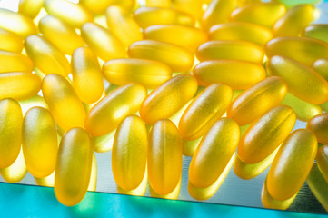 Large medical capsules and tablets-vitamins and nutritional supplements on a blue background. Close up. Selective focus