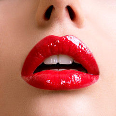 Closeup beautiful female lips with red lipstick.