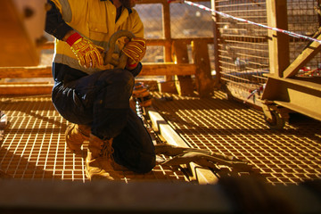 Rigger setting wearing fall safety protection helmet working inspecting fastening pin into D- shape...