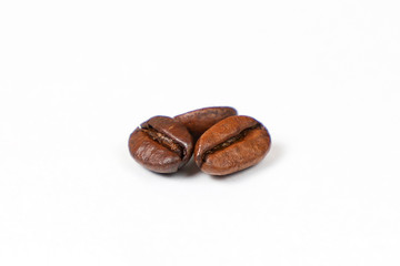 Roasted coffee beans on a white background.