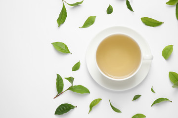 Flat lay composition with green tea on white background