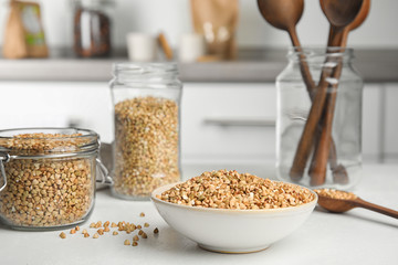 Uncooked green buckwheat grains on white table