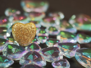 Golden heart covered with glitter on a glass design element. Saint Valentine abstract background.