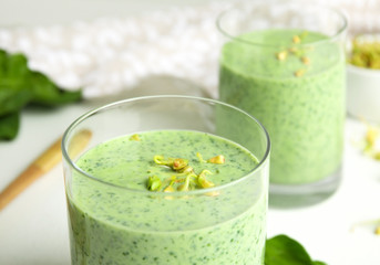 Green buckwheat smoothie on white table, closeup