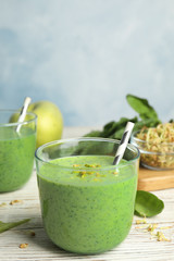 Green buckwheat smoothie on white wooden table