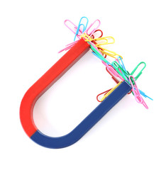 Magnet attracting paper clips on white background, top view