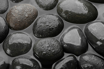 Spa stones in water as background, top view. Zen lifestyle