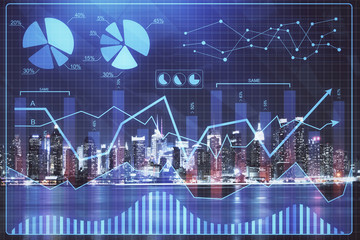 Financial graph on night city scape with tall buildings background multi exposure. Analysis concept.