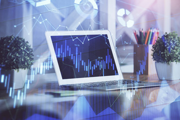 Forex market graph hologram and personal computer on background. Multi exposure. Concept of...