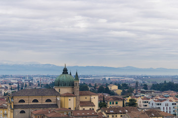 Fototapeta na wymiar Italian city view, church and buildings in North Italy - Image
