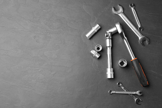 Auto mechanic's tools on grey background, flat lay. Space for text