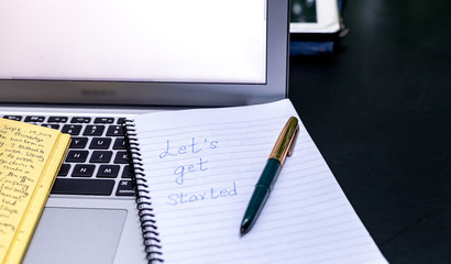 Blogger concept. There is a pc laptop with notebook and pen at a table in a cafe. selective focus