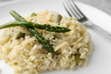Delicious risotto with asparagus in plate, closeup