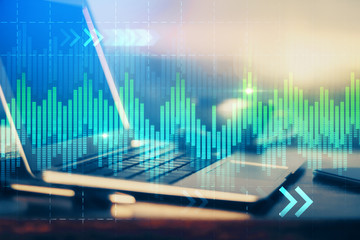 Double exposure of chart and financial info and work space with computer background. Concept of international online trading.