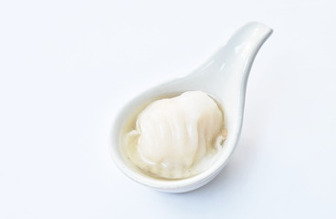 Ha Kao or white dumpling stuffed mashed shrimp and pork dressing soup on spoon 