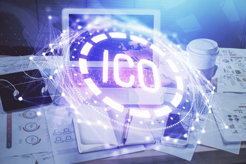 Double exposure of blockchain theme hologram and table with computer background. Concept of bitcoin crypto currency.