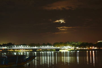 bridge cross river and reflection light bulb on night in Vietnam