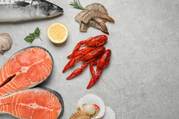 Fresh fish and seafood on light grey table, flat lay