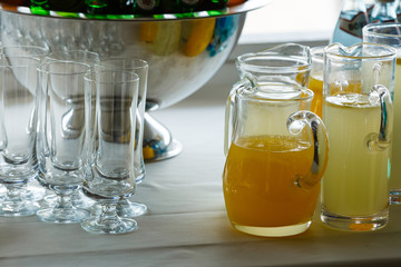 Refreshing fruit drinks of lemon and orange taste. Pitcher and glasses for drinks