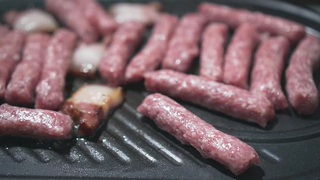 Grilling bacon and kebabs, delicious meat, indescribable aroma. Pan from right to left.