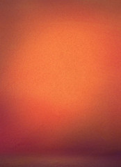 Orange photographic studio background vertical with soft vignette. Soft gradient background. Painted canvas studio backdrop or muslin cloth wall and floor