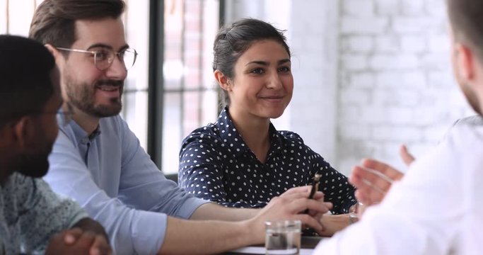 Smiling indian hr member talking to job applicant during interview