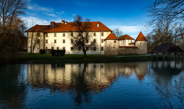 Otocec Castle on the Krka River in Slovenia, beautiful scene with reflection on water.