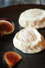Delicious white soft round cheese with mold with figs. Copy space. Selective focus
