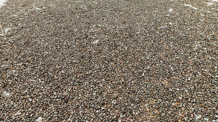 Lots of small gray wet rock stones on the road in Anatolia