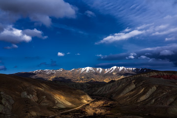 Wide angle panoramic view of the mountain peaks covered with snow