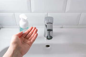 Going to wash hands over the sink in the bathroom, indoors. Concept healthcare and hygiene