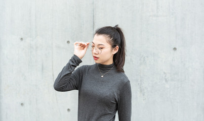  young woman standing in front of concrete wall