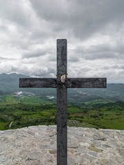 Iron cross covered with rust on the mountain