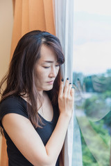 sadness and depress woman, absent minded, Staring out of the window in white tone