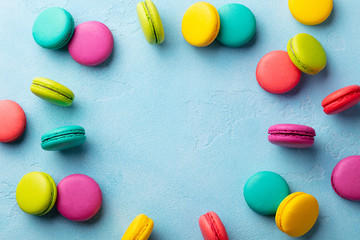 Macaroons dessert on blue background. Flat lay composition. Copy space. Top view.