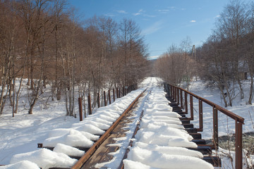 Railroad bridge covered with deep snow