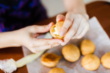 Obraz na płótnie Canvas Homemade eclairs. Preparation of eclairs in the home kitchen. The process of cooking eclairs.