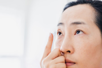 Beautiful Woman Putting Eye Lenses With Hands