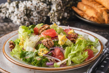 Fruit salad with garpefruit, cheese, lettuce and walnut.