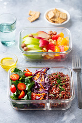 Lunch box with vegetables, brown rice and fruits salad. Healthy eating. Grey background.