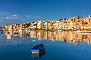 Fototapeta na wymiar Traditional fishing boats in marina of Birgu, Malta