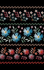 Embroidery seamless pattern with stripes of beautiful flowers on black background.  Floral ornament for fabric and textile. Fashion design.
