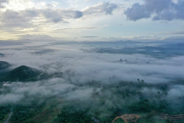 Aerial view misty and foggy morning at the Imbak Village in Tongod, Sabah, Malaysia, Borneo. Certain part with rainforest jungle and palm oil plantation.