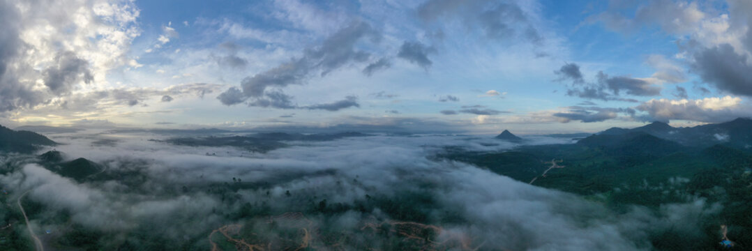 Aerial view misty and foggy morning at the Imbak Village in Tongod, Sabah, Malaysia, Borneo. Certain part with rainforest jungle and palm oil plantation.