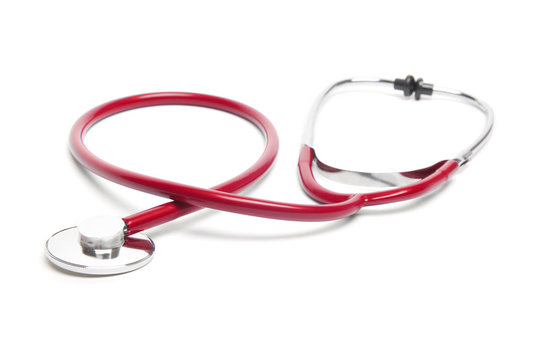 Shiny new medical stethoscope with red tubing curling on white background