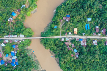 Aerial view of the wild river with the old wooden bridge connecting between two mainland in Kampung Imbak, Tongod, Sabah, Malaysia, Borneo.