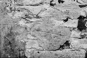 Texture of a concrete wall with cracks and scratches which can be used as a background
