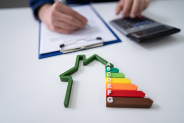 Businessman Calculating Energy Efficiency Rate