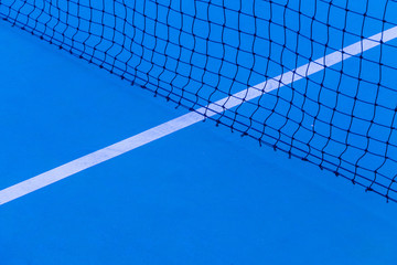 Blue tennis court surface, sport background..Detail of a tennis court.Tennis court with net...