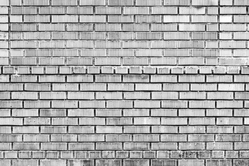 Texture of a brick wall with cracks and scratches which can be used as a background